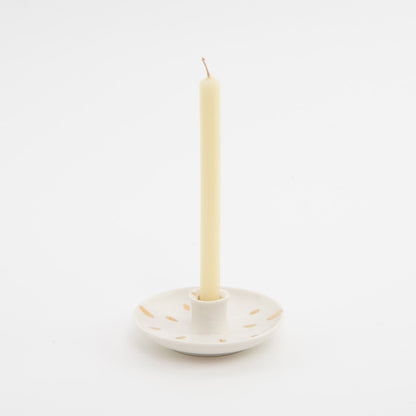 white ceramic candle holder with cream candle