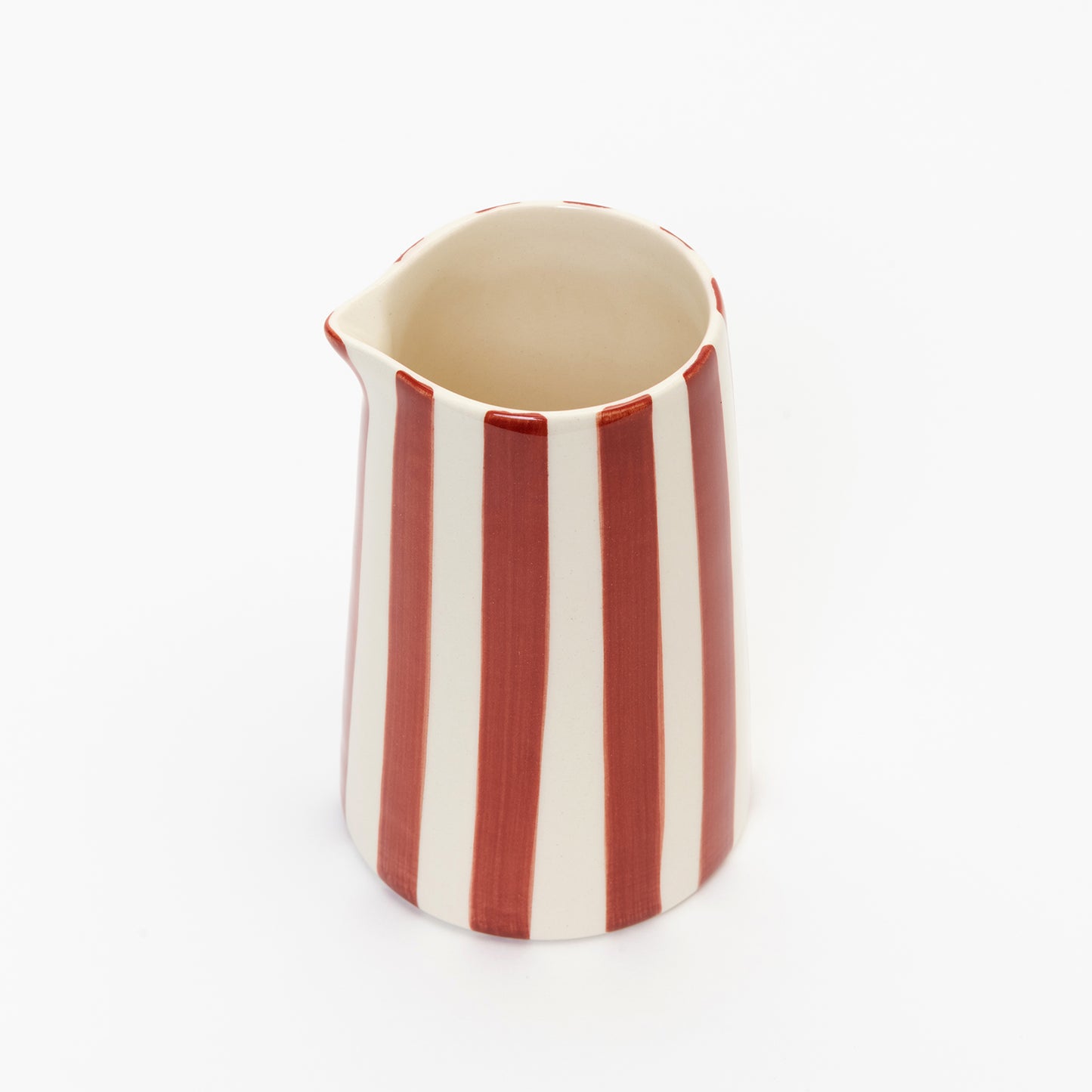 3/4 shot of red and white stripe creamer with no handle