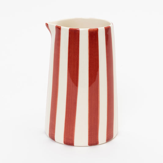 Side shot of red and white stripe creamer with no handle