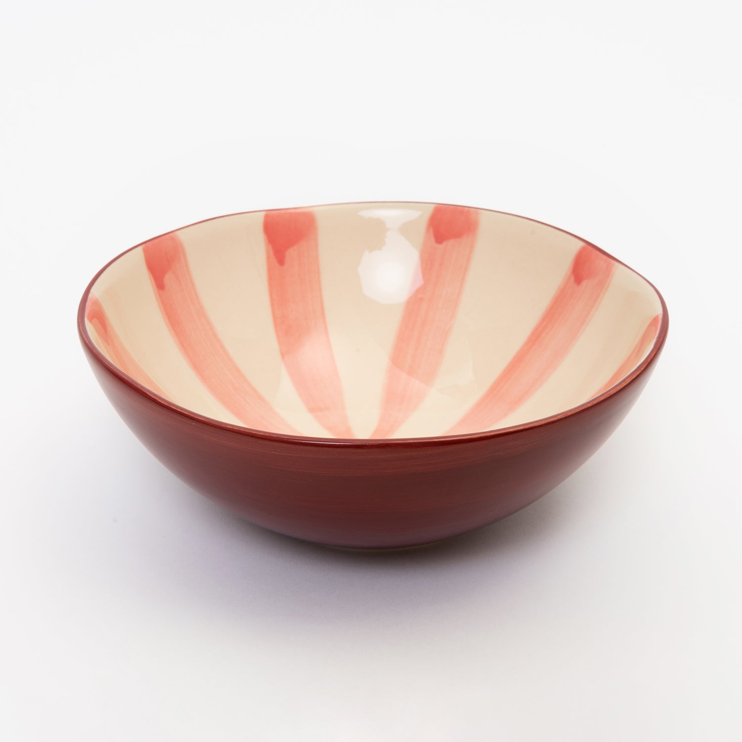 Light pink stripes meeting in the middle of the bowl with dark pink wash on the outside