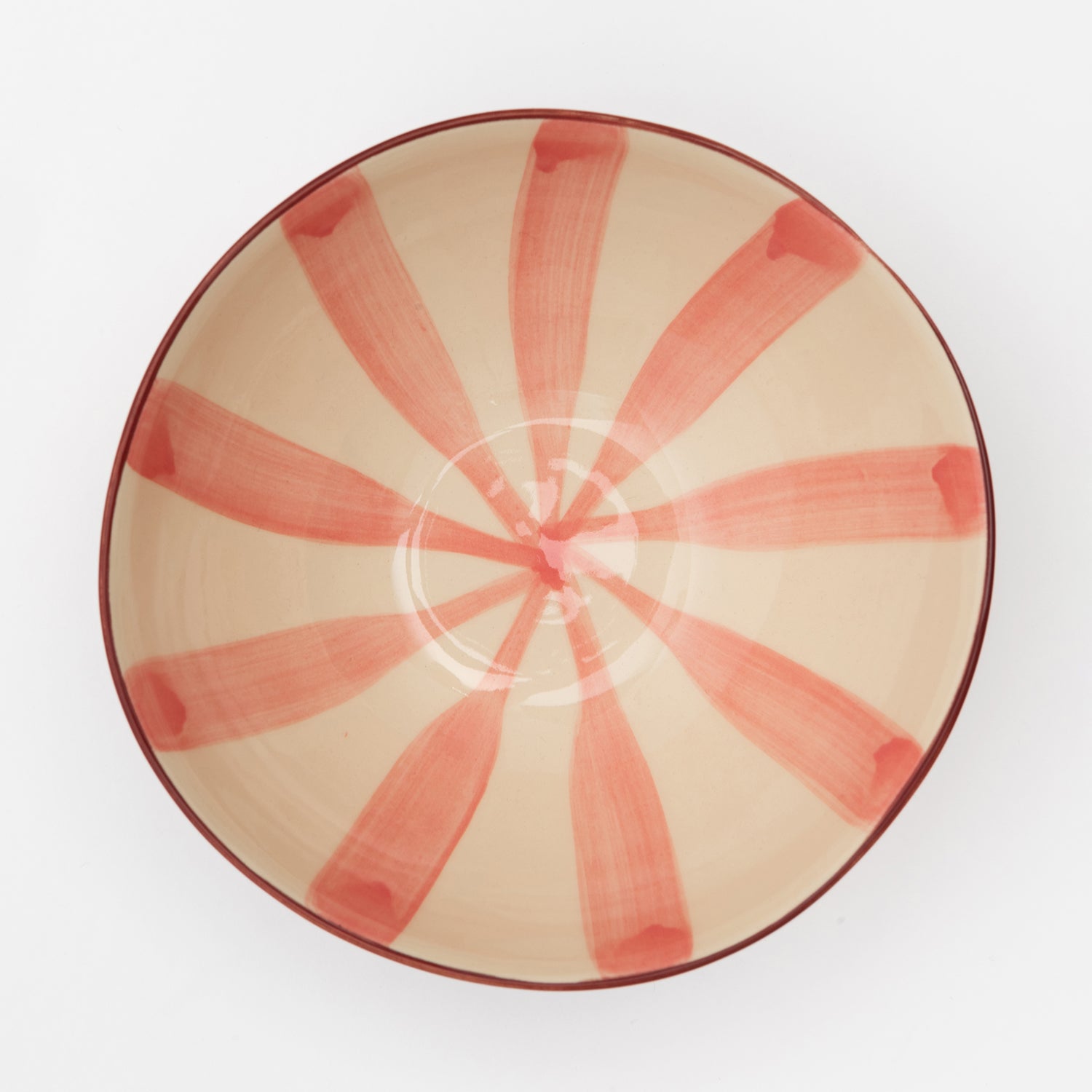 Light pink stripes meeting in the middle of the bowl with dark pink wash on the outside