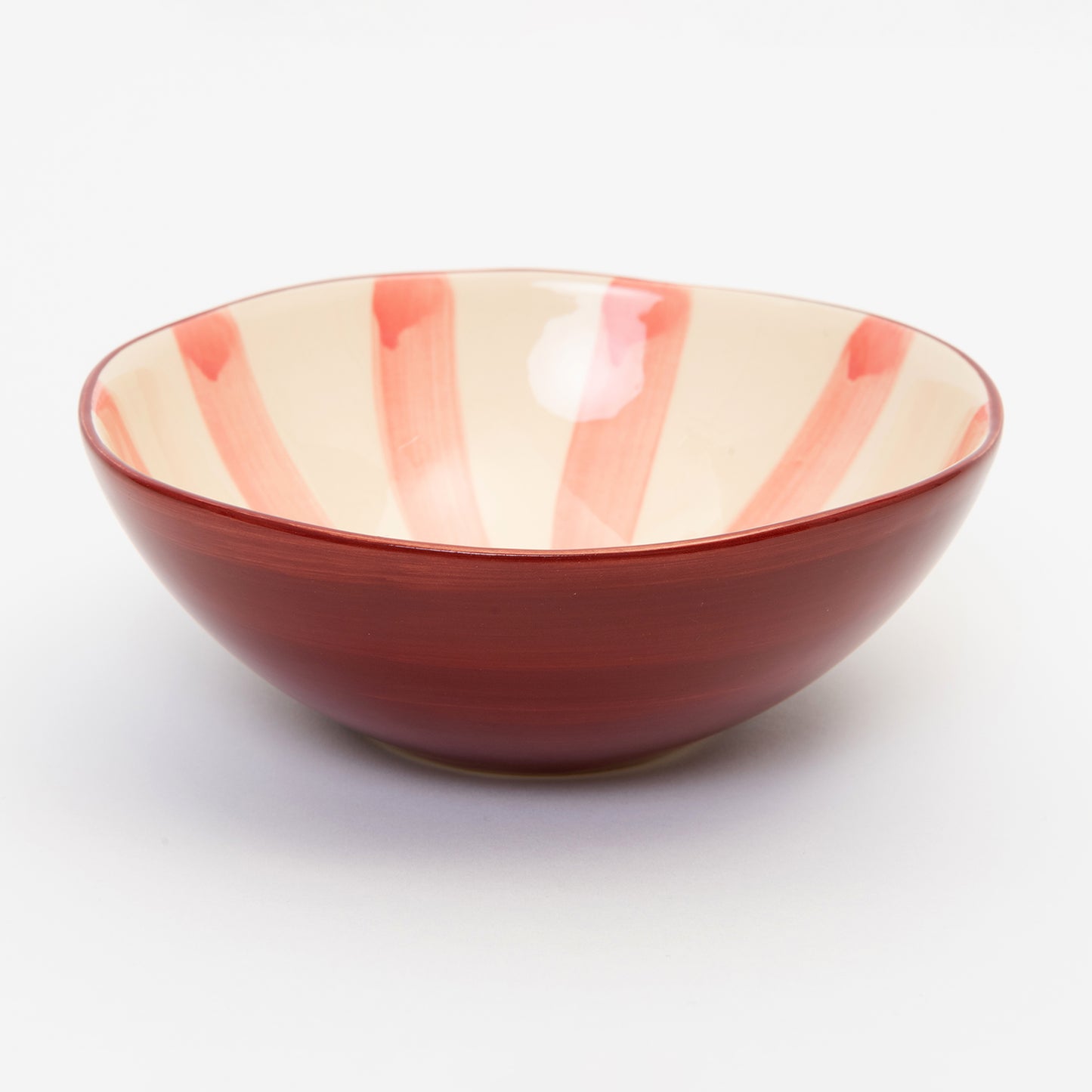 Light pink stripes meeting in the middle of the bowl with dark pink wash on the outside