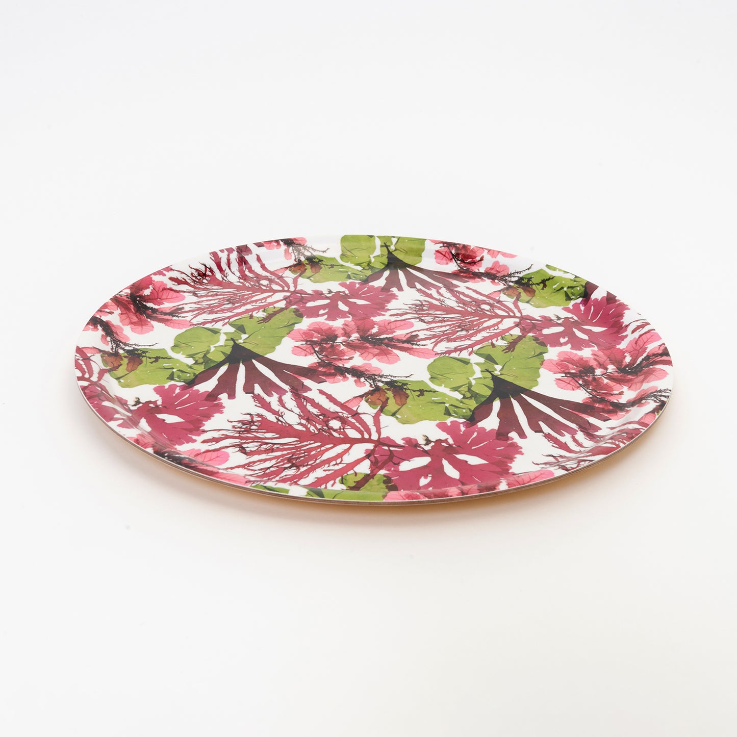 round tray with seaweed pressing design in pinks and greens