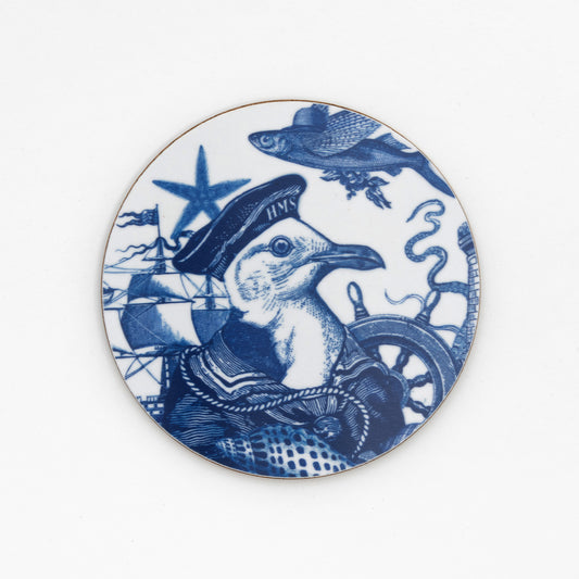 round coaster with blue image of a seagull wearing a captains hat  on a white background
