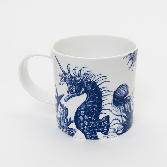 other side of white mug showing blue illustration of seahorse with a unicorn  horn