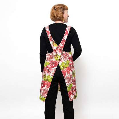 Back shot of model wearing the seaweed crossback apron in green and pink coloured seaweed design