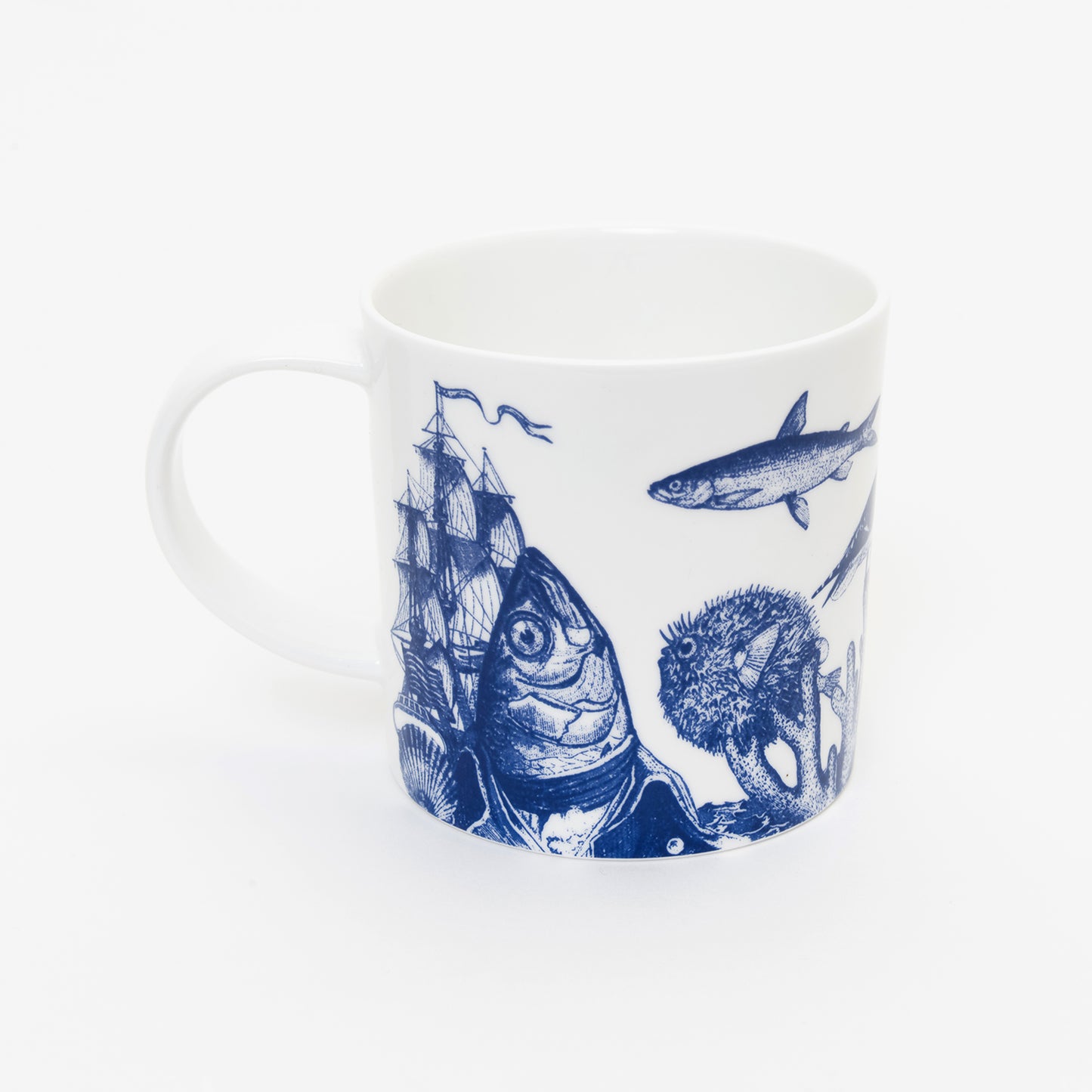 White mug with blue illustration of fish balancing shoe on its head