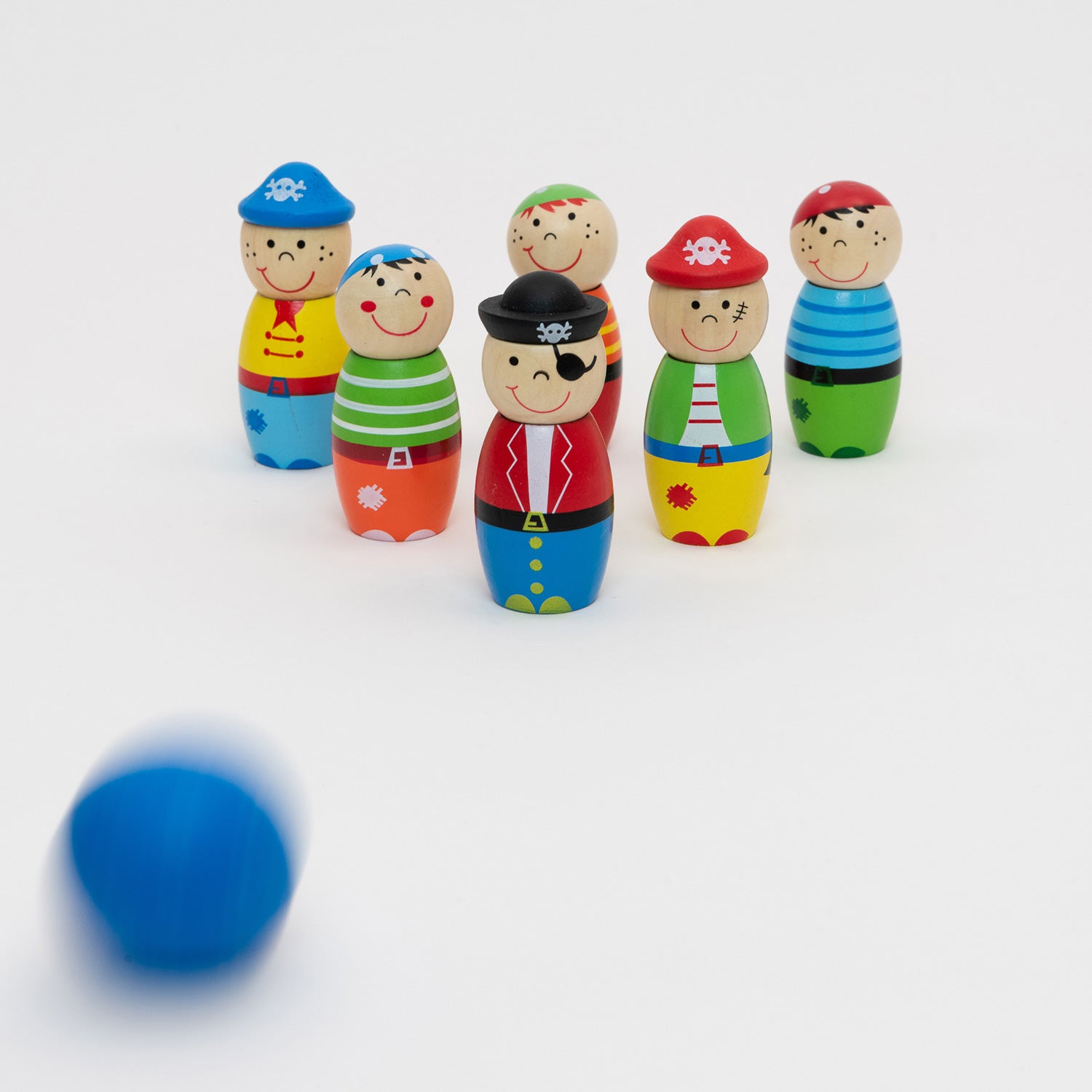 The wooden Pirate Skittles set up for a game of skittles with the blue ball moving towards the skittles.