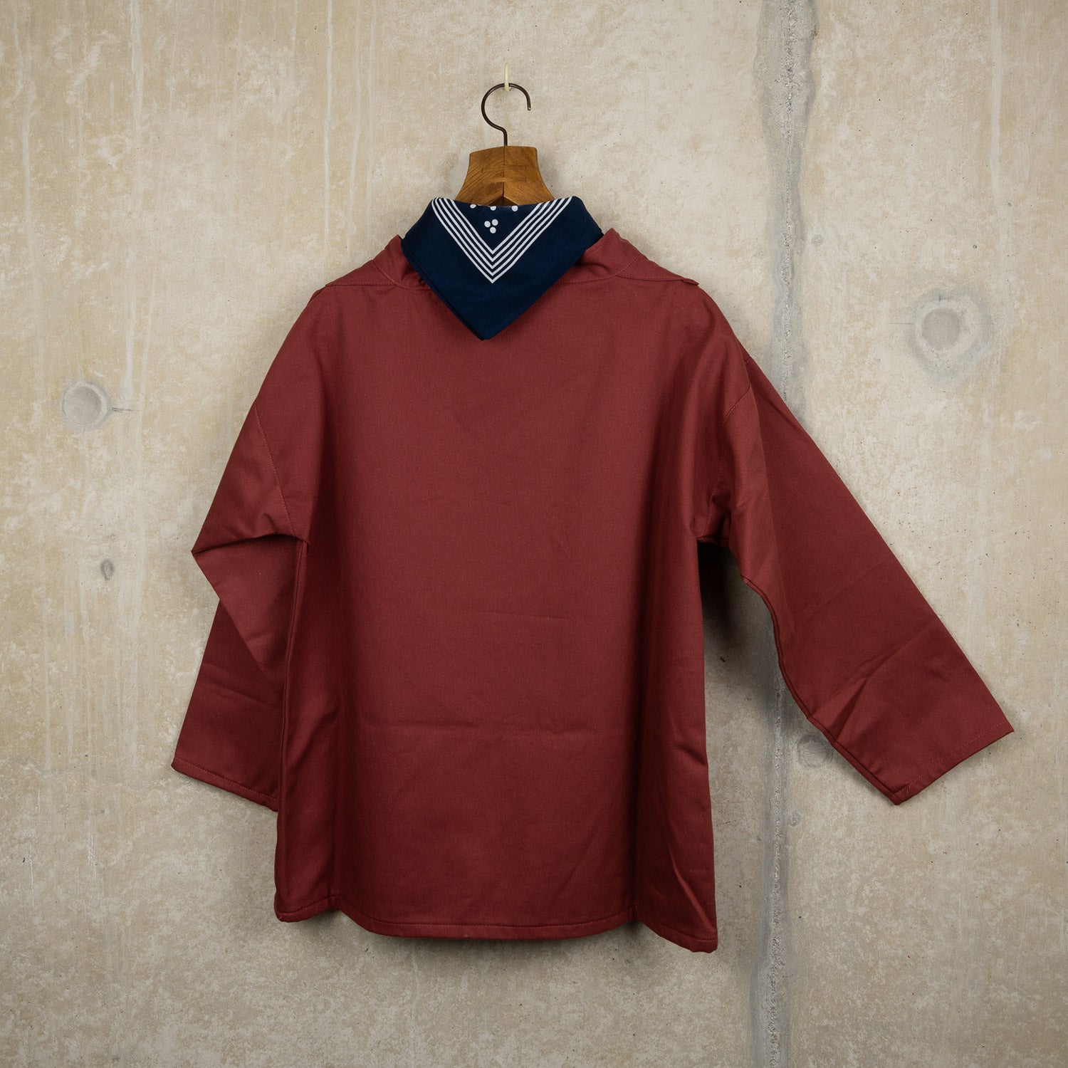 Back view of Breton red smock with crew neck, full-length sleeves and two front pockets