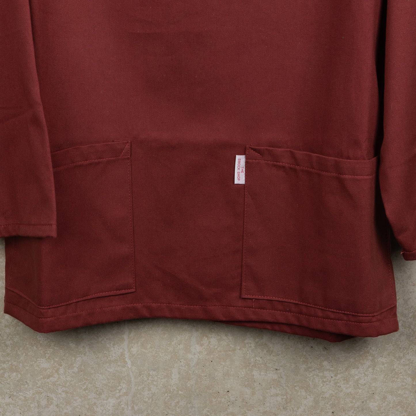 close up of Breton red smocks two front pockets
