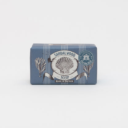 Packaged Cornish Sandalwood Soap on a white background. The packaging is dark blue with illustrations of a shell and seaweed.