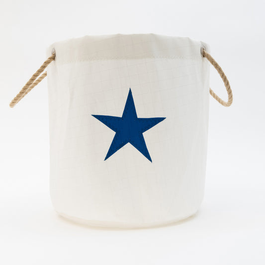 Round bucket bag in white with appliqued star in blue. Rope handles. 