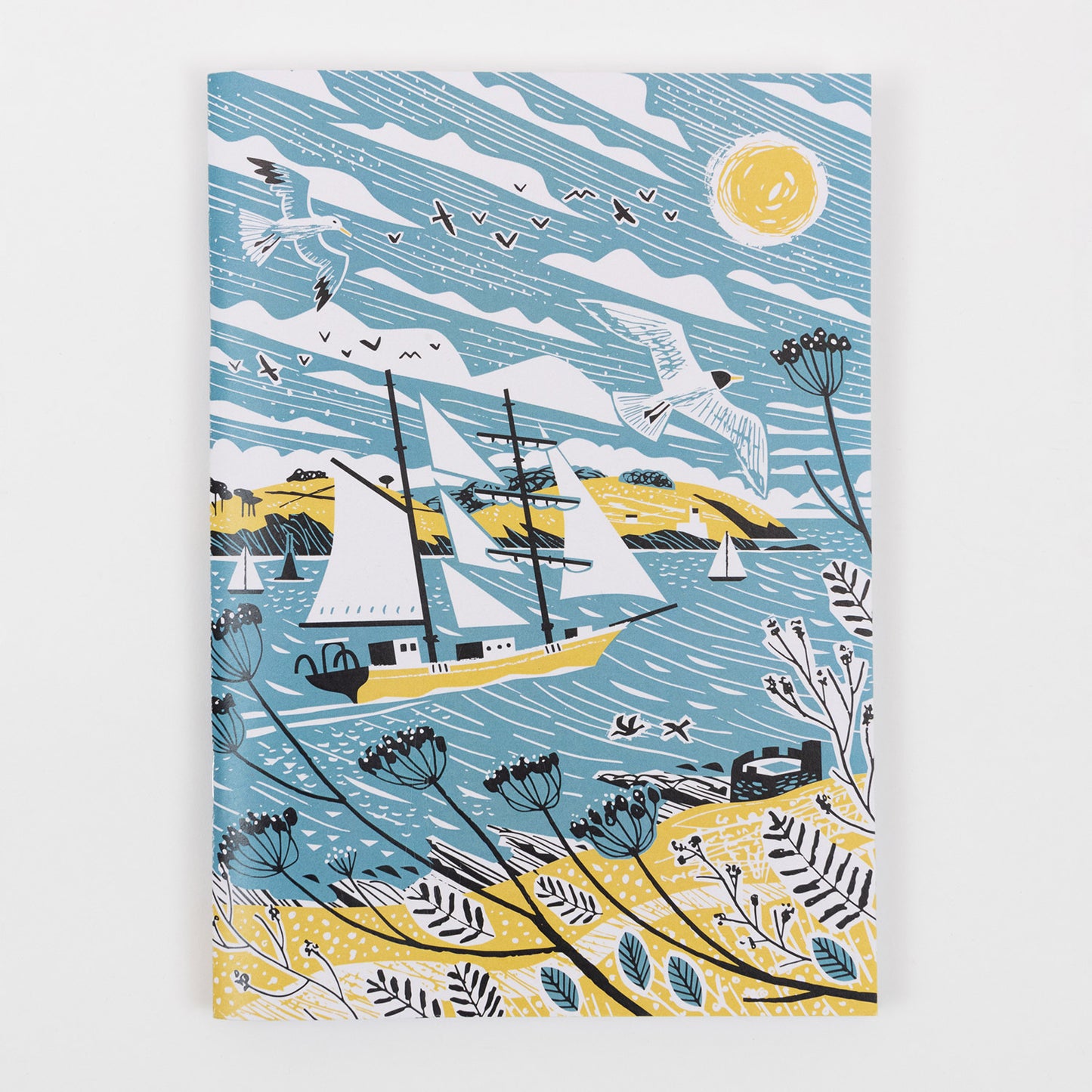 The front of the Falmouth Tall Ships Notebook featuring a yellow, blue and white illustration of a tall ship in full sail.
