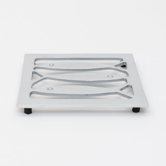 Top view of the stainless steel square trivet with fish cut outs and black rubber feet,