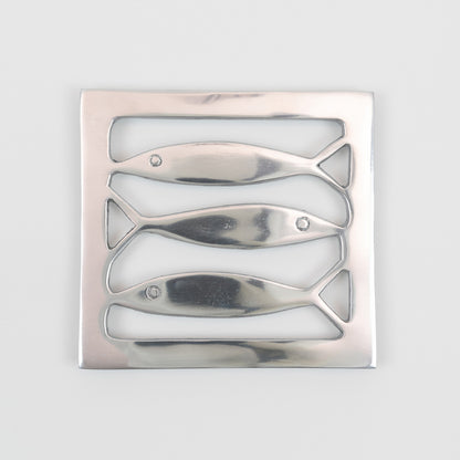 Top down view of the stainless steel square trivet with fish cut out pattern. 