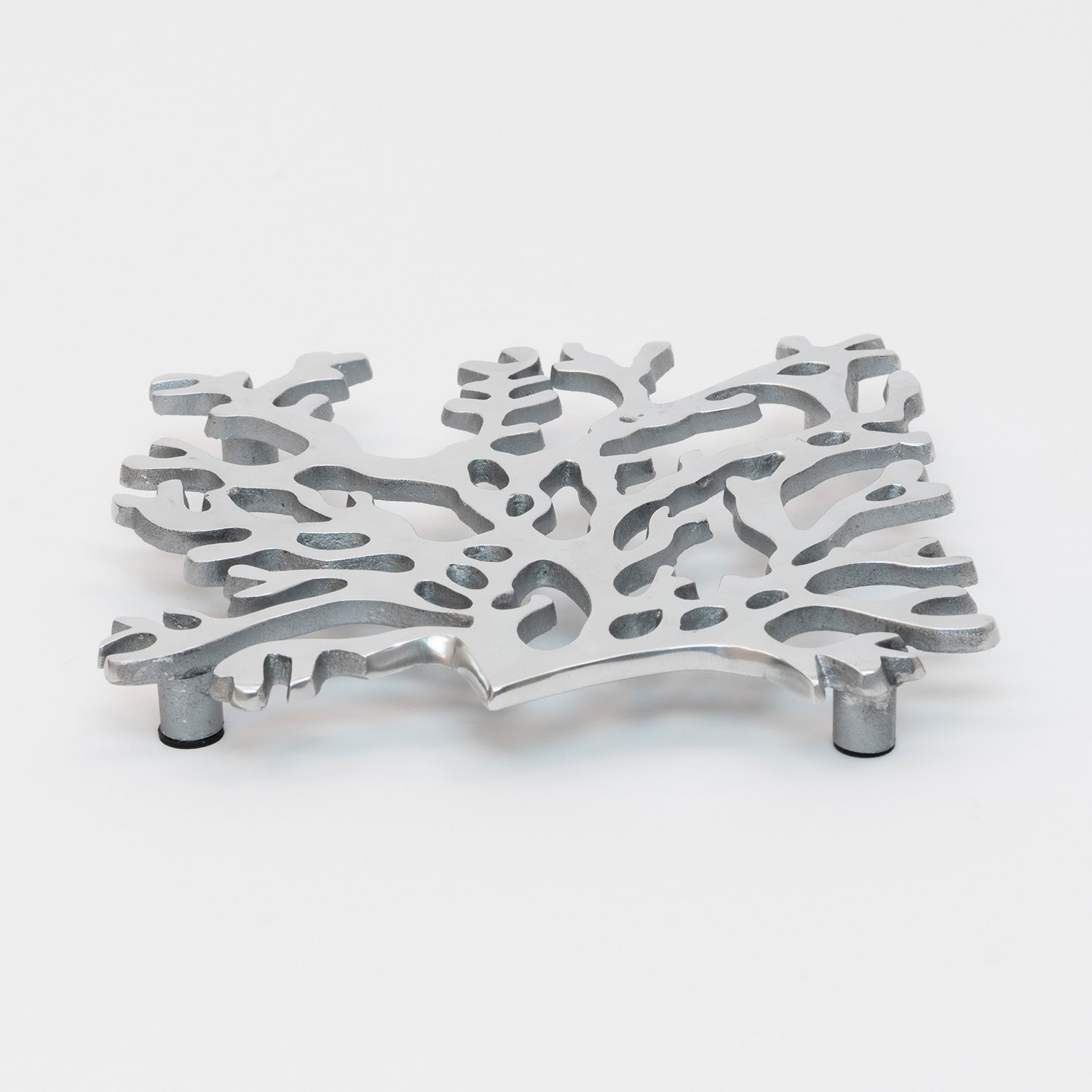 A top and side view of the stainless steel silver seaweed shaped trivet with black pads on the feet.